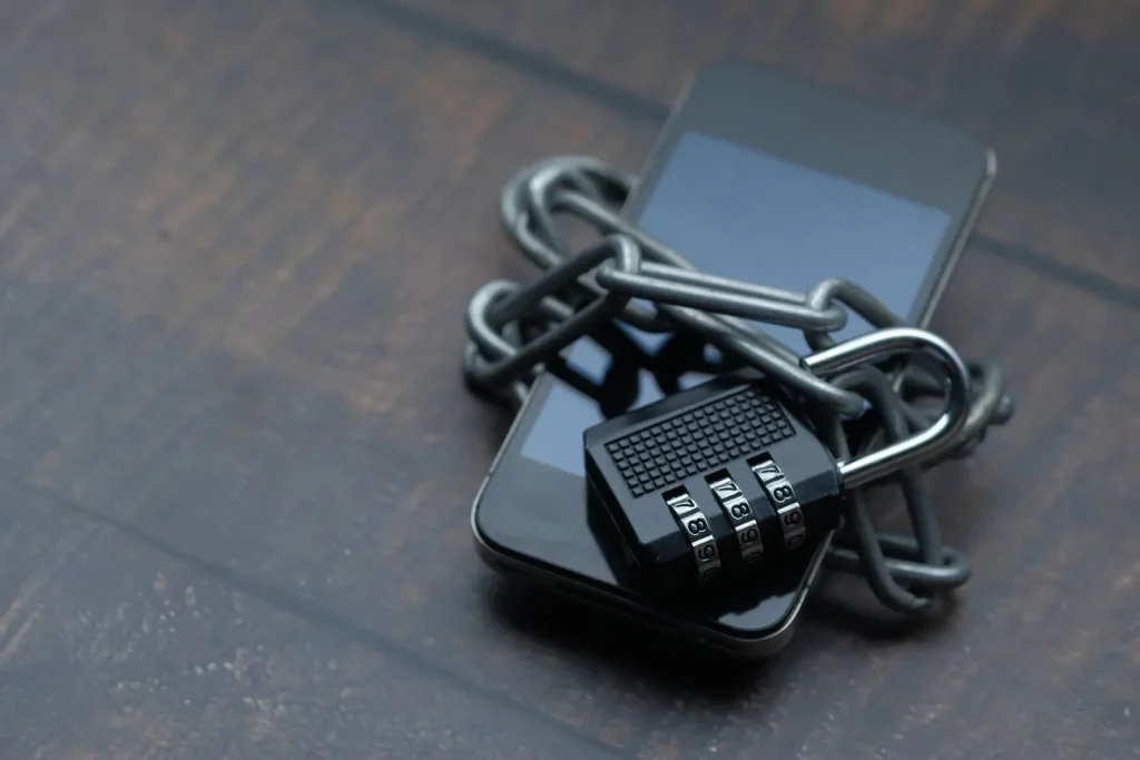 Smartphone wrapped in a chain and padlock, representing data security under Malaysia's PDPA