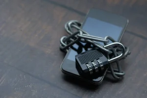 Smartphone wrapped in a chain and padlock, representing data security under Malaysia's PDPA